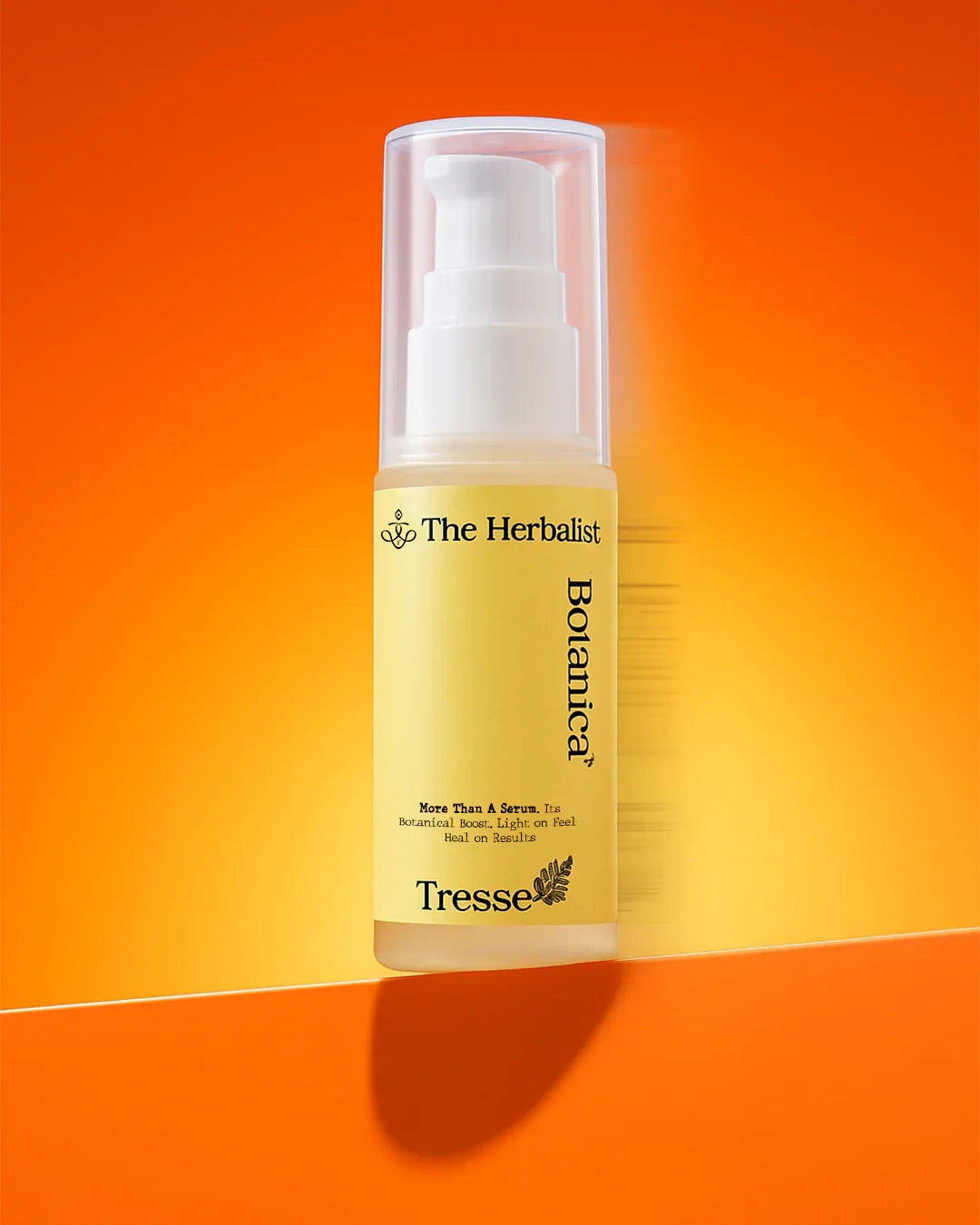 Botanical serum bottle with pump and yellow label on orange background
