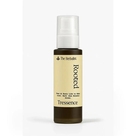Herbalist Rooted Tressence hair spray bottle with botanical ingredients on white background